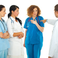 Angry Hospital manager points finger at doctor woman Angry Hospital manager points finger at doctor woman