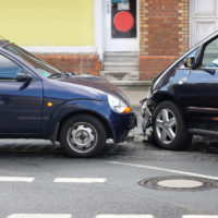 head-on car crash with damage at front of cars