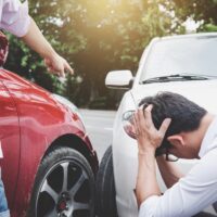 Two drivers man arguing after a car traffic accident collision, Traffic Accident and insurance concept