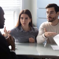 Angry clients couple argue with agent for paperwork contract mistake Angry clients couple argue with agent for paperwork contract mistake