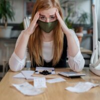 Frustrated manager sitting at table in closed cafe, small business lockdown due to coronavirus. Frustrated manager sitting at table in closed cafe, small business lockdown due to coronavirus.