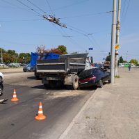 accident on a city road, a dump truck pinched a passenger car accident on a city road, a dump truck pinched a passenger car