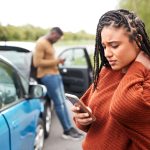 Female Motorist Involved In Car Accident Calling Insurance Company Or Recovery Service