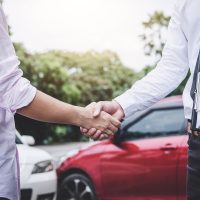 Insurance Agent and customer shaking hands after claim contact, Traffic Accident and insurance concept Insurance Agent and customer shaking hands after claim contact, Traffic Accident and insurance concept