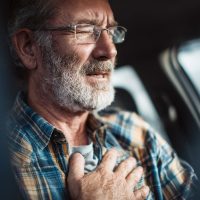 Car Accident Chest. Mature Adult Male Enduring Heart Attack While Driving