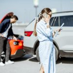 Woman calling with phone after the car collision