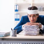 Head injured male employee working in the office