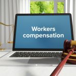 Workers compensation. Law. A lawyer laptop on a desk in the office. Text on the screen. Libra, Juctice, Web
