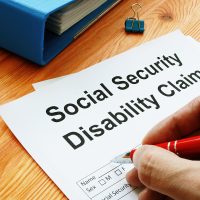 Man filling in Social Security Disability Claim.