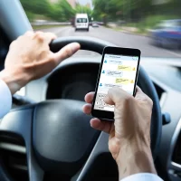 a-person-texting-on-a-smartphone-while-driving