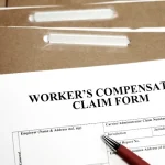 closeup-of-a-workers-compensation-claim-form-atop-brown-file-folders