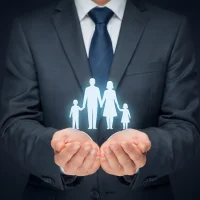 Businessman protecting holographic family with insurance symbolism