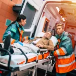 serious-and-professional-team-of-doctors-in-the-ambulance-moving-on-a-patient-into-the-hospital-during-an-emergency-situation