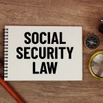 social-security-law-message-written-on-notepad-with-alarm-clock