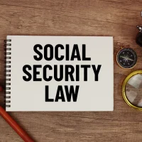 social-security-law-message-written-on-notepad-with-alarm-clock social-security-law-message-written-on-notepad-with-alarm-clock